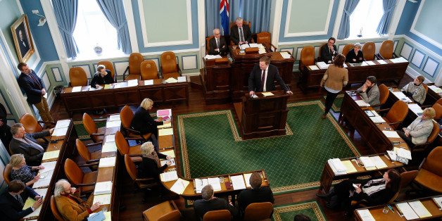 The Iceland's Prime Minister Sigmundur David Gunnlaugsson, centre, stands at the lectern to give a statement at the Parliament regarding the Panama papers released yesterday, in Reykjavik on Monday April 4, 2016. Iceland's prime minister insisted Monday he would not resign after documents leaked in a media investigation allegedly link him to an offshore company that could represent a serious conflict of interest, according to information leaked from a Panamanian law firm at the center of an inte