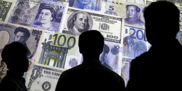 People are silhouetted against a backdrop projected with the picture of various currencies of money in this illustration taken April 4, 2016. REUTERS/Kacper Pempel/Illustration