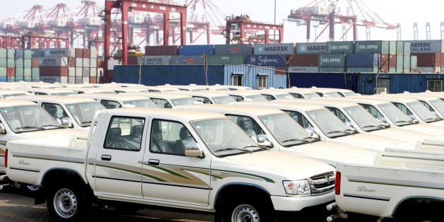 In this photo released by China's Xinhua News Agency, Chinese-made pickup trucks are about to be rolled onto a freighter at the roll-on roll-off wharf of Tianjin Port in North China, Monday, March 30, 2009. Some 1,300 pickups of Chinese auto brand Great Wall Motor are put onto stowage of an ocean freighter bound for Algiers Port of north Africa, the largest item of Chinese pickups export to overseas via the Tianjin port so far this year, Xinhua said. (AP Photo/Xinhua, Hu Ming) ** NO SALES **