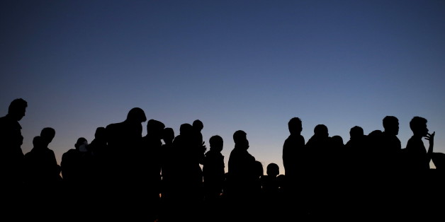 Migrants and refugees queue for food at a makeshift camp at the Greek-Macedonian border near the village of Idomeni, Greece, March 30, 2016. REUTERS/Marko Djurica