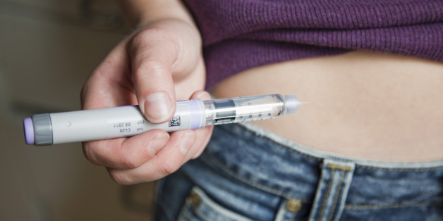 Girl holding a syringe with insulin