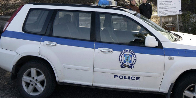 A police car is parked in front of the museum dedicated to the ancient Olympic Games in Olympia, on February 17, 2012, after masked armed robbers stole more than 60 ancient objects of 'incalculable' value, including a gold ring. Sixty-eight objects were whisked from a museum dedicated to the ancient Olympic Games after two masked men immobilised the museum's sole female guard as she arrived for her early morning shift, officials said. AFP PHOTO/ Menelaos Myrillas (Photo credit should read Menelaos Myrillas/AFP/Getty Images)
