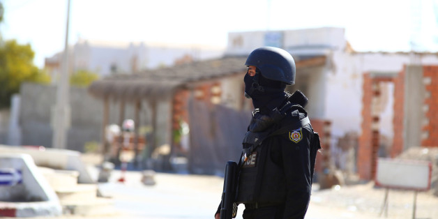 Tunisian police officers take positions as they search for attackers still at large in the outskirts of Ben Guerdane, southern Tunisia, Tuesday, Match 8, 2016. The death toll from clashes between Tunisian forces and extremist attackers near the Libyan border has risen to 55, including 36 attackers, Tunisian Prime Minister Habid Essid said Tuesday. (AP Photo/Feres Najar)