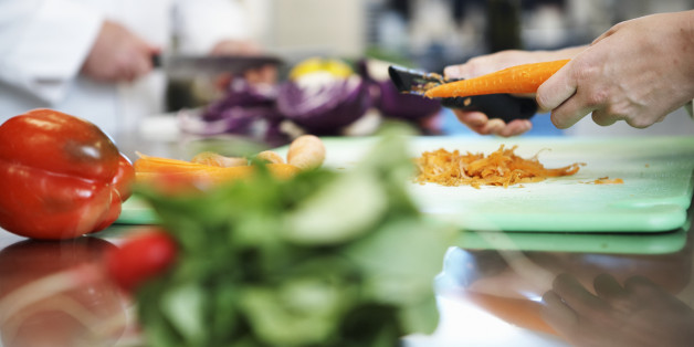 Cooks preparing food in kitchen, close-up