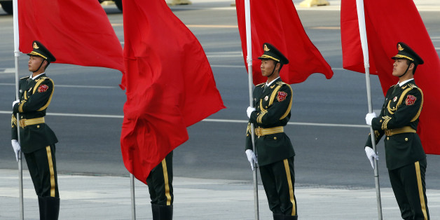 A red flag covers a soldier from Chinese honour guards during a welcoming ceremony for Swiss President Johann Schneider-Ammann at the Great Hall of the People in Beijing, China, April 8, 2016. REUTERS/Kim Kyung-Hoon