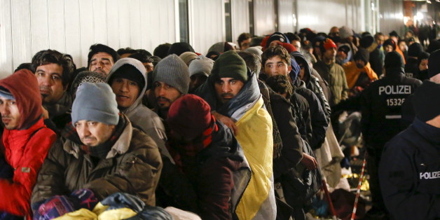 Migrants queue on a street to enter the compound outside the Berlin Office of Health and Social Affairs (LAGESO) for their registration process in Berlin, Germany, December 9, 2015. REUTERS/Fabrizio Bensch