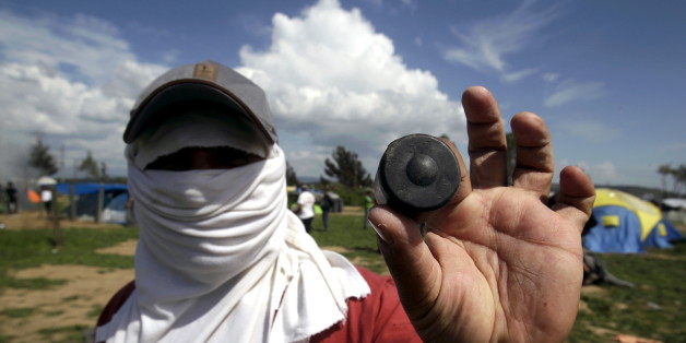 A protesting migrant displays a rubber bullet he says was fired by Macedonian police during clashes at a makeshift camp for refugees and migrants at the Greek-Macedonian border near the village of Idomeni, Greece, April 10, 2016. REUTERS/Alexandros Avramidis