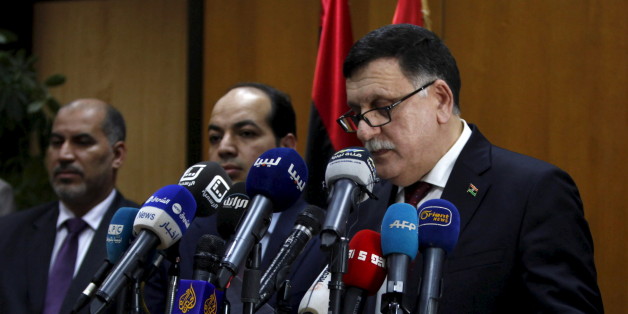 Libyan prime minister-designate under a proposed National Unity government Fayez Seraj (R) attends a news conference in Tripoli, Libya, March 30, 2016. REUTERS/Ismail Zitouny