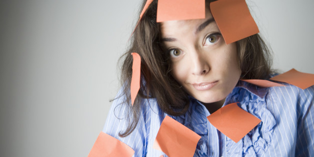 Portrait of a young woman covered with adhesive notes