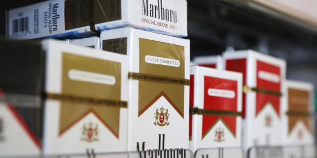 Packs of Marlboro cigarettes are displayed for sale at a convenience store in Somerville, Massachusetts July 17, 2014. Cigarette maker Philip Morris International Inc cut its earnings forecast for 2014 and said it is proving to be a "complex and truly atypical" year for the company. REUTERS/Brian Snyder (UNITED STATES - Tags: HEALTH BUSINESS)