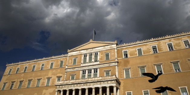 A Greek national flag flutters atop the parliament building in Athens, Greece April 11, 2016. REUTERS/Alkis Konstantinidis TPX IMAGES OF THE DAY