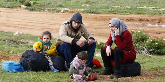 Syrian refugees wait on a roadside after Turkish police prevented them from sailing off to the Greek island of Farmakonisi by dinghies, near a beach in the western Turkish coastal town of Didim, Turkey, March 9, 2016. REUTERS/Umit Bektas