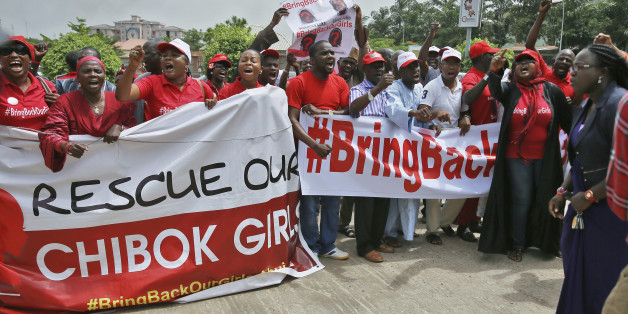Members of the #BringBackOurGirls campaign group protest on a street, after challenging the Nigerian police's ban on their daily protests, in Abuja June 3, 2014. Nigerian police said on Tuesday that protesters were free to march in the capital Abuja, after an uproar over comments by the police commissioner in which he appeared to ban demonstrations over more than 200 schoolgirls kidnapped by rebels. REUTERS/Afolabi Sotunde (NIGERIA - Tags: CIVIL UNREST CRIME LAW SOCIETY)