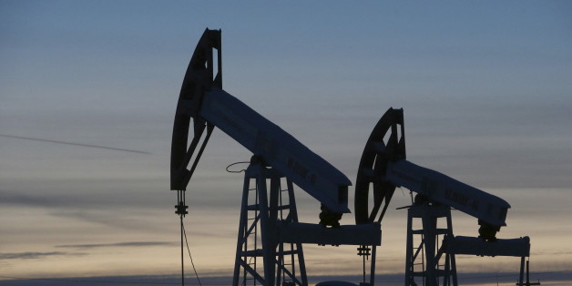 Pump jacks are seen at the Lukoil-owned Imilorskoye oil field, as the sun sets, outside the west Siberian city of Kogalym, Russia, in this January 25, 2016 file photo. To match Exclusive RUSSIA-OPEC/FREEZE REUTERS/Sergei Karpukhin/Files