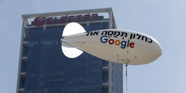 A blimp reading "Kahlon, tax Google", in reference to Finance Minister Moshe Kahlon, is seen floating near the building hosting Google's offices in Tel Aviv in this April 3, 2016 file photo. The other side of the blimp bears the English slogan "Google must pay tax". REUTERS/Baz Ratner/Files