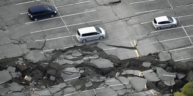 Cracks caused by an earthquake is seen at a parking lot in Minamiaso town, Kumamoto prefecture, southern Japan, in this photo taken by Kyodo April 16, 2016. Mandatory credit REUTERS/Kyodo ATTENTION EDITORS - FOR EDITORIAL USE ONLY. NOT FOR SALE FOR MARKETING OR ADVERTISING CAMPAIGNS. THIS IMAGE HAS BEEN SUPPLIED BY A THIRD PARTY. IT IS DISTRIBUTED, EXACTLY AS RECEIVED BY REUTERS, AS A SERVICE TO CLIENTS. MANDATORY CREDIT. JAPAN OUT. NO COMMERCIAL OR EDITORIAL SALES IN JAPAN.
