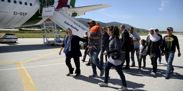 A group of Syrian refugees arrive to board a plane with Pope Francis at the airport of Mytilene, in the Greek island of Lesbos, April 16, 2016. REUTERS/Filippo Monteforte/Pool