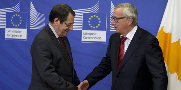 European Commission President Jean-Claude Juncker, right, greets Cypriot President Nicos Anastasiades prior to a meeting at EU headquarters in Brussels on Wednesday, March 16, 2016. The Cypriot president is in Brussels on Wednesday to meet with EU leaders prior to a summit on migration which begins Thursday. (AP Photo/Virginia Mayo)