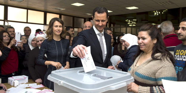 Syria's President Bashar al-Assad (C) casts his vote next to his wife Asma (centre left) inside a polling station during parliamentary elections in Damascus, Syria, in this handout picture provided by SANA on April 13, 2016. REUTERS/SANA/Handout via Reuters ATTENTION EDITORS - THIS PICTURE WAS PROVIDED BY A THIRD PARTY. REUTERS IS UNABLE TO INDEPENDENTLY VERIFY THE AUTHENTICITY, CONTENT, LOCATION OR DATE OF THIS IMAGE. FOR EDITORIAL USE ONLY. NOT FOR SALE FOR MARKETING OR ADVERTISING CAMPAIGNS.