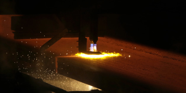A red-hot iron slab is processed on a rolling mill of the ArcelorMittal steelworks in Ostrava, Czech Republic, April 1, 2016. REUTERS/David W Cerny