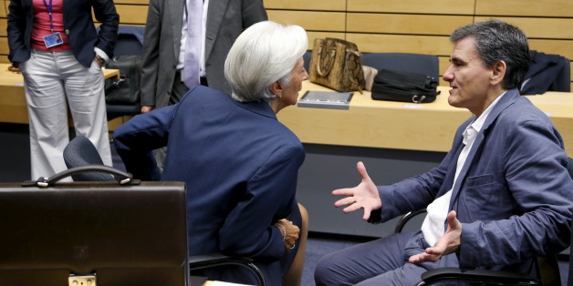 Greek Finance Minister Euclid Tsakalotos talks to International Monetary Fund (IMF) Managing Director Christine Lagarde (L) during an euro zone finance ministers meeting in Brussels, Belgium, July 12, 2015. Euro zone leaders will fight to the finish to keep near-bankrupt Greece in the euro zone on Sunday after the European Union's chairman cancelled a planned summit of all 28 EU leaders that would have been needed in case of a "Grexit". REUTERS/Francois Lenoir
