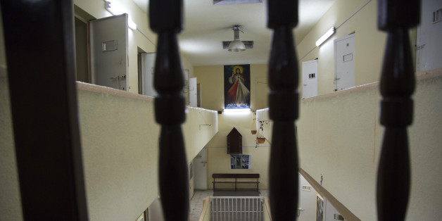 In this April 14, 2015 photo, a poster of Jesus hangs in the now empty Garcia Moreno Prison, during a guided tour for the public in Quito, Ecuador. After prisoners were transferred out in September, guides began giving 30 minute tours through the facility where tourists can get a first hand look at the cells where inmates slept, as well as the common areas. (AP Photo/Dolores Ochoa)