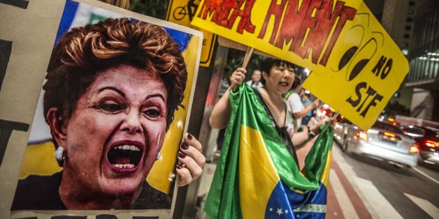 SAO PAULO, BRAZIL - APRIL 14: A woman holds a banner during a protest against the government of president of Brazil Dima Roussef at Paulista Avenue on April 14, 2016 in Sao Paulo, Brazil. Goverment of Brazil is attempting to block efforts to impeach President Dilma Roussefff by asking the Supreme Court to annul the process in Congress and suspend a key vote scheduled for Sunday. (Photo by Chris Faga/LatinContent/Getty Images)