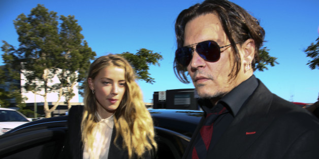 US actor Johnny Depp (R) and his wife Amber Heard arrive at a court in the Gold Coast on April 18, 2016. Depp and Heard arrived at an Australian court April 18 over Heard's alleged illegal importation of their two Yorkshire terrier dogs Boo and Pistol into the country in a private jet in 2015, as Depp was in Australia for the filming of the latest Pirates of the Carribean movie. / AFP / Patrick HAMILTON (Photo credit should read PATRICK HAMILTON/AFP/Getty Images)