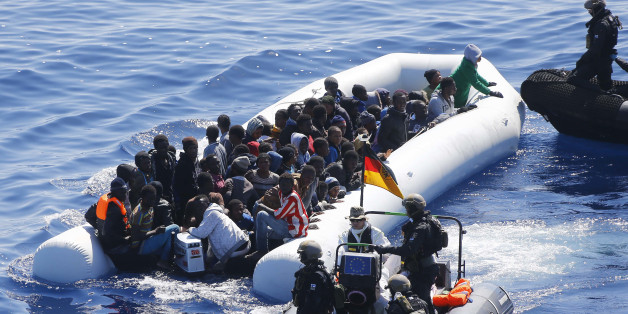 In this March 29, 2016 picture German Navy sailors ad Finish Special Forces surround a boat with migrants near the German combat supply ship 'Frankfurt am Main' during EUNAVFOR MED Operation Sophia in the Mediterranean Sea off the coast of Libya . (AP Photo/Matthias Schrader)