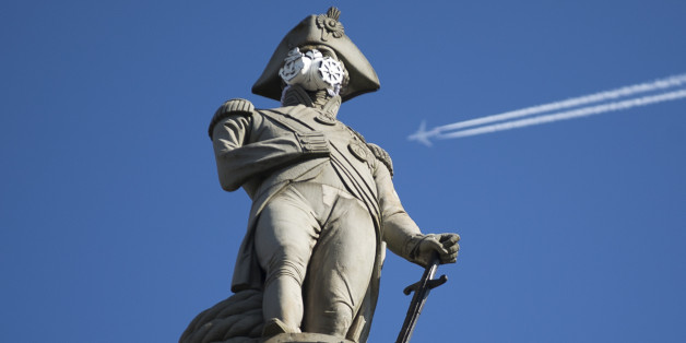 A clean air mask is seen placed on the top of Nelson's Column by Greenpeace activists to protest against air pollution quality in London and cities across the UK, in London, Monday, April 18, 2016. (AP Photo/Matt Dunham)
