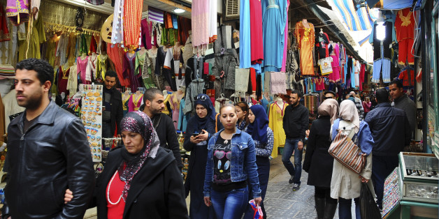Tunisians walk in a market of Tunis, Friday, March 20, 2015. Yet another terror attack is taking its toll on tourism, with cruise companies cancelling stops in Tunisia following the killings of 21 people. Seventeen of those killed at the Bardo National Museum in Tunis were passengers on shore excursions from two cruise ships in port that day. (AP Photo/Salah Ben Mohamed)
