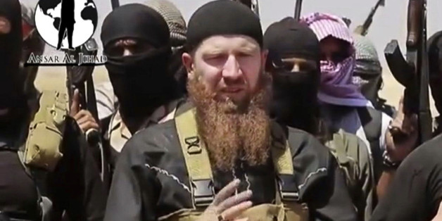 FILE - This image made from undated video posted during the weekend of June 28, 2014 on a social media account frequently used for communications by the Islamic State of Iraq and the Levant (ISIL), which has been verified and is consistent with other AP reporting, shows Omar al-Shishani standing next to the group's spokesman among a group of fighters as they declare the elimination of the border between Iraq and Syria. An Iraqi official and a Syrian activist say senior Islamic State group leader