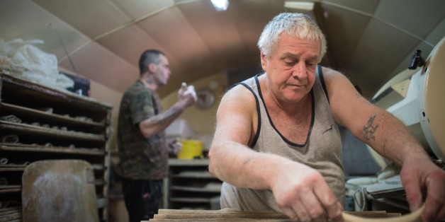 Michel Flamant (R) and Jerome (L) work in their bakery on March 23, 2016, in Dole, eastern France.
Michel Flamant, the owner of the bakery decided to teach baking and pastry to Jerome and to sell him his bakery for one symbolic euro, after Jerome saved his life. / AFP / SEBASTIEN BOZON (Photo credit should read SEBASTIEN BOZON/AFP/Getty Images)