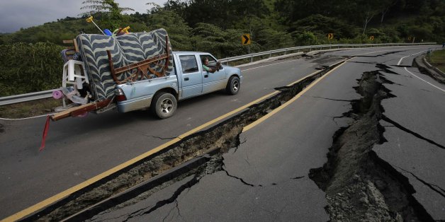 A truck moves the belongings of a family from Pedernales, over the earthquake destroyed road to Jama, in Ecuador, Monday, April 18, 2016. A Saturday night quake left a trail of ruin along Ecuadorâs Pacific Ocean coast. Hundreds have died, thousands are homeless and without electricity. (AP Photo/Dolores Ochoa)