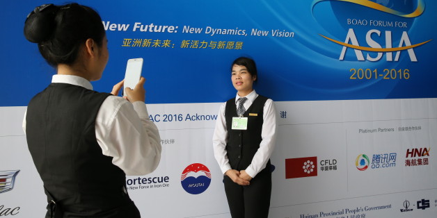 A member of the staff takes pictures with her mobile phone during Boao Forum in Boao, Hainan Province, March 22, 2016. REUTERS/China Daily ATTENTION EDITORS - THIS PICTURE WAS PROVIDED BY A THIRD PARTY. THIS PICTURE IS DISTRIBUTED EXACTLY AS RECEIVED BY REUTERS, AS A SERVICE TO CLIENTS. CHINA OUT. NO COMMERCIAL OR EDITORIAL SALES IN CHINA.