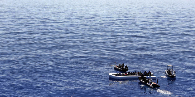 In this March 29, 2016 picture German Navy sailors and Special Forces from Finland help migrants prior to board the German combat supply ship 'Frankfurt am Main' during o EUNAVFOR MED Operation Sophia in the Mediterranean Sea off the coast of Libya . (AP Photo/Matthias Schrader)