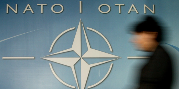 A woman walks past the NATO logo at the entrance of the Alliance
headquarters ahead of a NATO foreign ministers meeting in Brussels
December 4, 2003. Transatlantic strains over EU defence ambitions were
set to overshadow a session of NATO foreign ministers on Thursday, as
they did when the alliance's defence ministers met earlier in the
week.
REUTERS/Thierry Roge