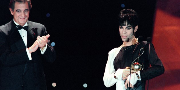 This photo taken on May 4, 1994 shows musician Prince (R) acknowledging applause after receiving from Italian tenor Placido Domingo (L) the 'Outstanding Contribution to the Pop Industry' award during the World Music Awards ceremony in Monaco.
Pop icon Prince -- whose pioneering brand of danceable funk made him one of music's most influential figures -- died on April 21, 2016 at his compound in Minnesota. He was 57. The announcement came just a week after the Grammy and Oscar winner was taken to hospital with a bad bout of influenza, although he made light of his health problems after the scare.
/ AFP / Patrick HERTZOG (Photo credit should read PATRICK HERTZOG/AFP/Getty Images)