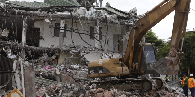 An excavator clears debris from a collapsed building in Portoviejo, after an earthquake struck off Ecuador's Pacific coast, April 22, 2016. REUTERS/Henry Romero
