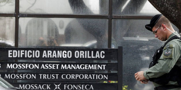Police officers stand guard next to a company list showing the Mossack Fonseca law firm outside their office in Panama City April 12, 2016. REUTERS/Carlos Jasso