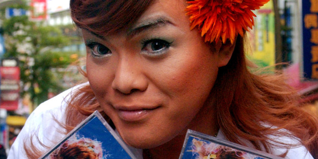 Famed Japanese singer Ken Maeda holds copies of his new trance-style music recording "Koi No Buchaiage Tengoku" during a media event, Wednesday, Dec. 28, 2005, in Taipei, Taiwan. (AP Photo/Chiang Ying-ying)
