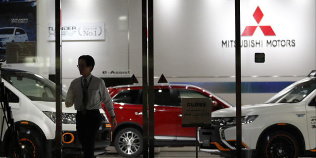 TOKYO, JAPAN - APRIL 20: An employee walks past a Mitsubishi Motors vehicles displayed at the company's headquarters on April 20, 2016 in Tokyo, Japan. Mitsubishi Motors share plunged more than 15% after the Japanese car maker announced it has mishandled the fuel economy test data. (Photo by Tomohiro Ohsumi/Getty Images)
