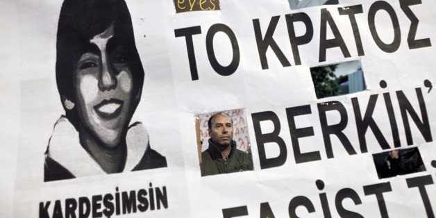 A protester in seen through a banner depicting late Turkish Berkin Elvan during a rally in solidarity to the anti-government protesters in Turkey, in Athens March 13,2014. Turkey's Prime Minister Tayyip Erdogan condemned anti-government protesters on Thursday as "charlatans" bent on sowing chaos in the run-up to local elections after Turkey's worst civil unrest since mass protests last summer. Elvan, a 15-year-old boy who was wounded during anti-government demonstrations last summer died on Tues