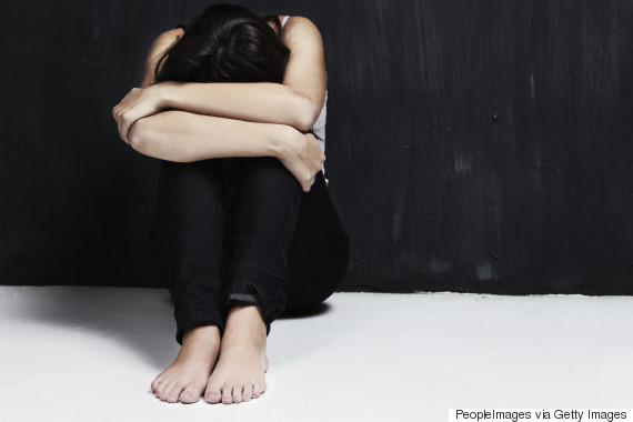 sad woman sitting on floor