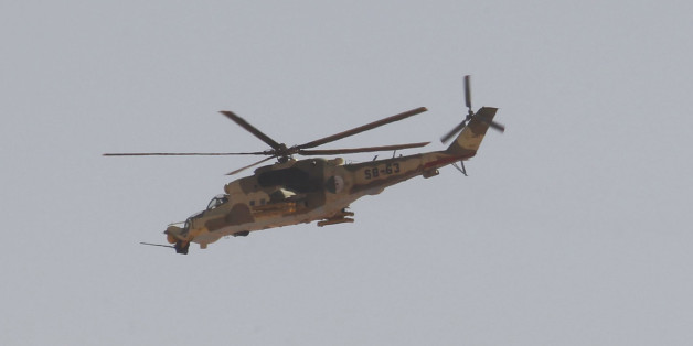 An Algerian military helicopter flies over Amenas city, south east of Algiers, where Islamist militants have been holding foreigners hostage, January 19, 2013. More than 20 foreigners were captive or missing inside a desert gas plant on Saturday, nearly two days after the Algerian army launched an assault to free them that saw many hostages killed. The standoff between the army and al Qaeda-linked gunmen - one of the biggest international hostage crises in decades - entered its fourth day, havin