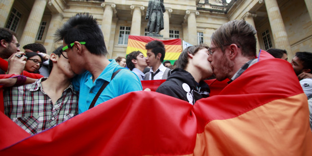 People kiss during a protest demanding the rights of the lesbian, gay, bisexual, and transgender (LGBT) community, at the Congress building in Bogota November 27, 2012. The protest was also against Senator Roberto Gerlein's recent derogatory comments on homosexuality during a debate on a proposed gay marriage bill in Congress, according to local media. REUTERS/John Vizcaino (COLOMBIA - Tags: SOCIETY CIVIL UNREST POLITICS)