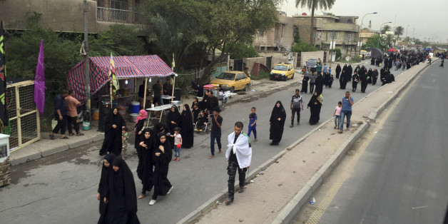 Shiite pilgrims march toward the Imam Mousa al-Kadhim shrine to commemorate the anniversary of the Imam's death in Baghdad, Iraq, Friday, April 29, 2016. The anniversary of the 8th-century Imam's death draws tens of thousands of Shiites from all walks to converge on his golden-domed shrine in northern Baghdad. The pilgrims typically march to the shrine while hundreds of tents are erected to offer them free food, drinks and services. (AP Photo/Ali Abdul Hassan)