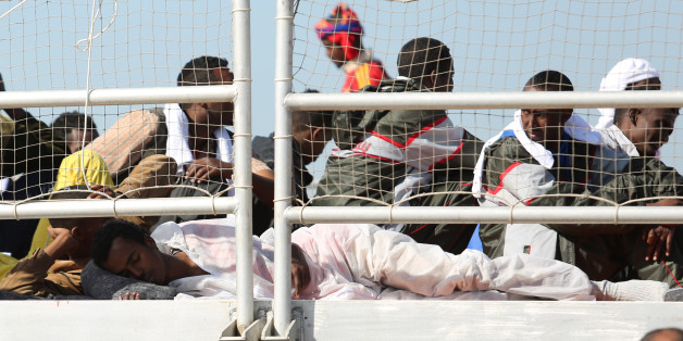 Migrants wait to disembark from the Migrant Offshore Aid Station vessel ' Phoenix ' in the harbor of Augusta, Sicily, Southern Italy, Saturday, May 9, 2015. European Union plans to introduce a quota system obliging countries to share the burden of settling refugees unraveled Friday as member nations began rejecting the scheme. (AP Photo/Francesco Malavolta)