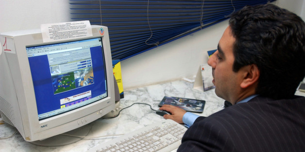 ** ADVANCE FOR TUESDAY NOV. 15 ** A Tunisian man surfs the web at a "Publinet", a Tunisian internet cafe in downtown Tunis, Wednesday, Nov. 9, 2005. Tunisia, host of next week's U.N. technology summit, happens to be one of the world's worst Internet censors, blocking Web sites its government opposes. (AP Photo/Hassene Dridi)
