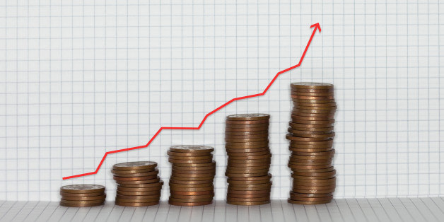 Stacks of coins on graph paper background with red arrow.